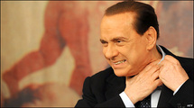 Berlusconi to stand trial, vows to cling to power