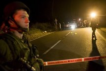 Israeli soldiers standing guard near the site where an Israeli settler was shot dead