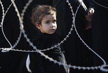 A Shiite Muslim girl watching a procession during an Ashura ceremony