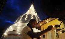 A Sri Lankan woman lights a candle to remember the country's 31,000 tsunami victims A Sri Lankan woman lights a candle to remember the country's 31,000 tsunami victims