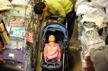 A girl sleeping as her father shops A girl sleeping as her father shops