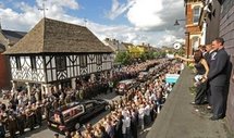 Mourners in Wootton Bassett in 2009, throwing flowers on hearses carrying the bodies of eight British soldiers killed in Afghanistan (AFP/File/Carl de Souza)