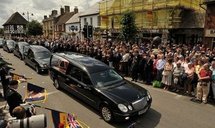 Mourners and well-wishers pay their respects as hearses carrying the bodies of four British soldiers killed in Afghanistan pass through Wootton Bassett (AFP/File/Carl de Souza)