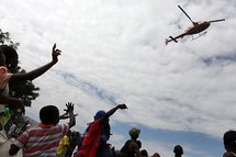 People wave at a helicopter in the centre of Port-au-Prince People wave at a helicopter in the centre of Port-au-Prince