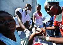 An injured woman is treated at a makeshift hospital in Port-au-Prince
