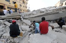 People on the rubble of their home in Port-au-Prince