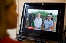 A woman watches footage in November 2009 of Paul and Rachel Chandler (AFP/File/Leon Neal)