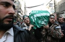 Mourners carry the coffin of Mahmud al-Mabhuh