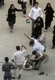 Iranian plain clothes policemen beat a demonstrator in Tehran in 2009