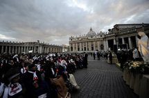 People pray in front of a statue of Our Lady of Lourdes in Vatican City People pray in front of a statue of Our Lady of Lourdes in Vatican City
