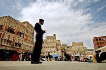 A Yemeni policeman stands guard in Sanaa