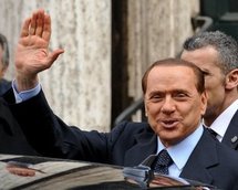 Italian Prime Minister Silvio Berlusconi waves as he leaves a memorial mass for his mother (AFP/Andreas Solaro)