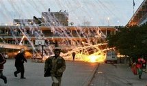 Palestinian civilians run for cover during an Israeli air strike over a UN school in Beit Lahia, in January 2009 (AFP/File/Mohammed Abed)