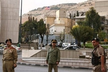 Syrian police stand guard outside the US embassy in Damascus (Louai Beshara/AFP)