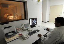A hospital employee performs a magnetic resonance scan on a patient in 2009 A hospital employee performs a magnetic resonance scan on a patient in 2009