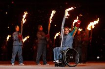 Torch bearer Marni Abbott-Peter waves during the opening ceremony of the Paralympics in Vancouver
