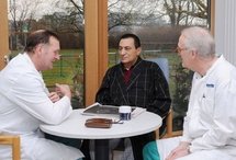 This picture released by the Egyptian Ministry of Information shows Hosni Mubarak (centre) talking to German doctors at the University of Heidelberg hospital (AFP/HO)