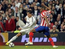 Real Madrid's Cristiano Ronaldo (left) and Atletico Madrid's Luis Perea during a Spanish league football match. (AFP/Pedro Armestre)