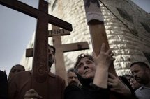 Eastern European Orthodox Christians walk the Via Dolorosa in Jerusalem's Old City during a Good Friday procession. (AFP/Marco Longari) Eastern European Orthodox Christians walk the Via Dolorosa in Jerusalem's Old City during a Good Friday procession. (AFP/Marco Longari)