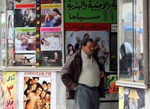 A Syrian man buys a ticket to watch a movie at a cinema in Damascus.