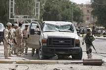 Iraqi security officials inspect the damage outside the Iranian embassy in central Baghdad. (AFP/Ahmad al-Rubaye)