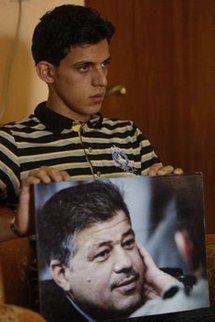 Samer, son of killed Reuters news agency chauffeur Saeed Chmagh, shows a picture of his father during an interview at his home in Baghdad. (AFP/Ahmad al-Rubaye)