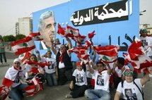 Lebanese people in front of a banner with a portrait of Rafiq Hariri. Lebanese people in front of a banner with a portrait of Rafiq Hariri.