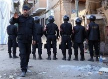 Egyptian police stand guard in a street in the southern Egyptian village of Bahgura in late January 2010. (AFP/File/Victoria Hazou)