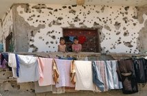 Palestinian girls stand on the balcony of their ruined house, hit during Israel's 22-day offensive, in Rafah in 2009. (AFP/File/Said Khatib)