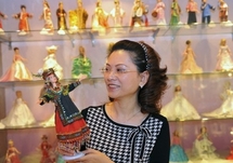 Ku Chai-ra, a former Mattel worker, displays a Barbie doll dressed in traditional Taiwanese costume in Taishan, Taipei, in March 2010.