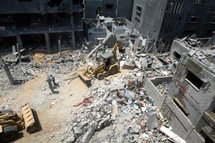 Bulldozers search in the ruin after Israel dropped a one-tonne bomb on a densely populated neighbourhood in Gaza in 2002.