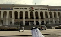 An Emirati man walks past the Dubai courts.