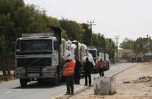 Hamas policemen inspect trucks carrying clothes and shoes as they pass the Kerem Shalom crossing on 4th April. (AFP/File/Said Khatib) Hamas policemen inspect trucks carrying clothes and shoes as they pass the Kerem Shalom crossing on 4th April. (AFP/File/Said Khatib)