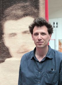 French bookseller Alban Causse with a picture of Rimbaud. French bookseller Alban Causse with a picture of Rimbaud.