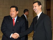 Syrian President Bashar Al-Assad shakes hands with Venezuelan President Hugo Chavez.