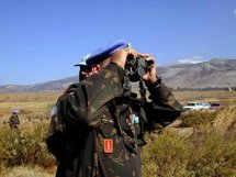 A UN officer scans the Shebaa Farms area with his binoculars. A UN officer scans the Shebaa Farms area with his binoculars.