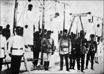 A picture from 1915 shows Turkish soldiers standing next to hanged Armenians. A picture from 1915 shows Turkish soldiers standing next to hanged Armenians.