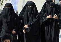 Saudi women cross a street in Hofuf city.