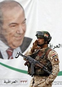 An Iraqi soldier stands in front of a portrait of former Iraqi premier Iyad Allawi in Baghdad on 17th April.