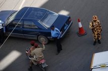 Yemeni police and soldiers secure the site of a suicide bombing that targeted the convoy of the British ambassador in Sanaa.
