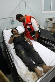 A medic attends to a wounded Palestinian youth at Al-Najar hospital in Rafah, in the southern Gaza strip. A medic attends to a wounded Palestinian youth at Al-Najar hospital in Rafah, in the southern Gaza strip.