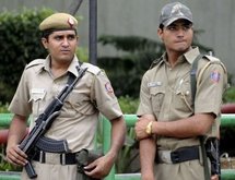 Indian policemen stand alert on a street in New Delhi. Indian policemen stand alert on a street in New Delhi.