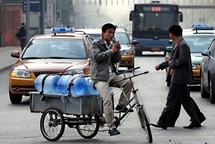 A water delivery man smokes while stuck in traffic in Beijing.