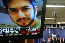 An image of Faisal Shahzad is seen on a TV screen as US Attorney General Eric Holder, Secretary of the Department of Homeland Security Janet Napolitano, Deputy Director of the FBI John S. Pistole and New York Police Commissioner Raymond Kelly hold a brief