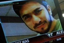 An image of Faisal Shahzad is shown on a television screen during a press conference at the US Justice Department in Washington.