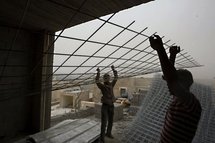 Palestinian labourers work on a construction site in the east Jerusalem settlement of Ramat Shlomo.