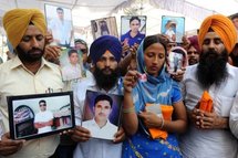 In Amritsar, relatives hold photographs of Indians sentenced to death for killing a Pakistani in the UAE. In Amritsar, relatives hold photographs of Indians sentenced to death for killing a Pakistani in the UAE.