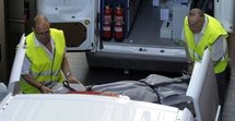 Members of the emergency services carry out the body of one of the two murdered children from a hotel in Lloret del Mar on 18th May.