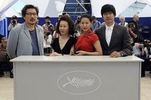 From left to right: South Korean director Hong Sang-soo, South Korean actresses Youn Yuh-jung and Ye Jiwon, and South Korean actor Yu Joonsang during a photocall for 'Ha ha ha'. From left to right: South Korean director Hong Sang-soo, South Korean actresses Youn Yuh-jung and Ye Jiwon, and South Korean actor Yu Joonsang during a photocall for 'Ha ha ha'.