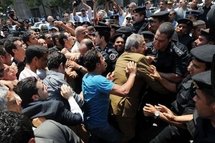 A protester scuffles with police during a demonstration near the parliament building in downtown Cairo on 3rd May, to demand fair elections as well as constitutional reforms and an end to emergency laws.